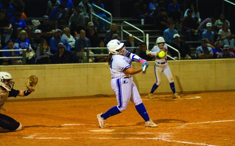 HUNTER KING | DISPATCH RECORD Amari Munoz drives a ball to the wall in center field to drive in a run on Monday night.