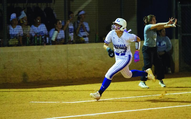 HUNTER KING | DISPATCH RECORD Brooklyn Farmer rounds third and heads home to score a run against Llano.