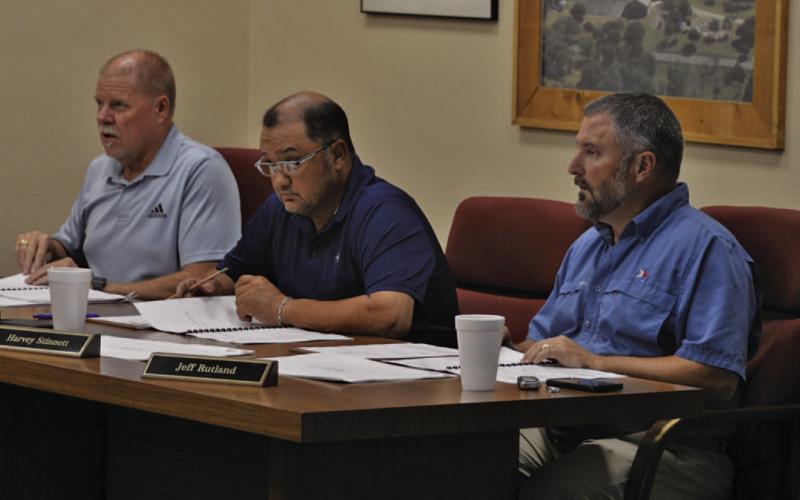 Trustees Randy Morris, at left, Harvey Stinnett in center and Jeff Rutland listen to a presentation at last week’s Lampasas ISD Board of Trustees meeting. The school board will convene in a called meeting tonight at 5 p.m. to consider additional construction options for Lampasas Middle School. ERICK MITCHELL | DISPATCH RECORD