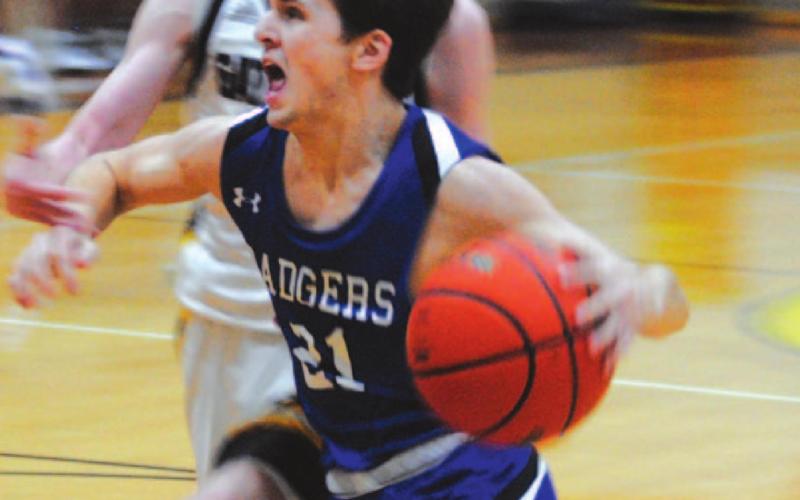 Austin Wilson drives to the basket against a Gatesville defender in last Friday’s contest. HUNTER KING | DISPATCH RECORD