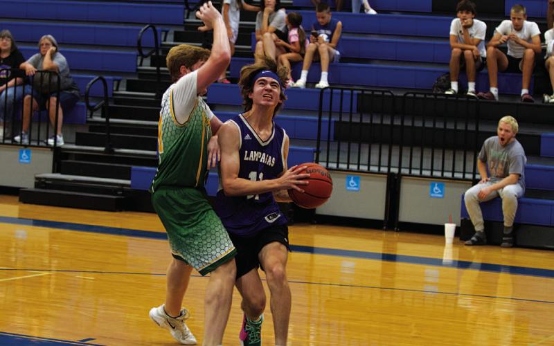 HUNTER KING | DISPATCH RECORD Jax Pratus drives to the basket during the Badgers’ second game of the Saturday tournament.