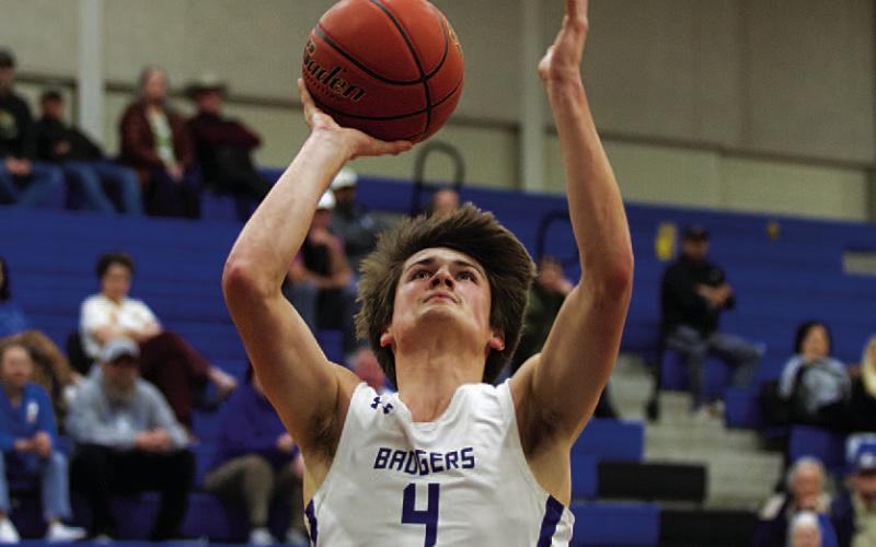 Calum Mitchell goes up for a layup during the home tournament. HUNTER KING | DISPATCH RECORD