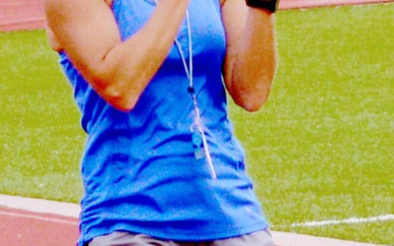 Christy Wiley cheers on athletes during Speed, Weights and Agility Training on Wednesday. JEFF LOWE | DISPATCH RECORD
