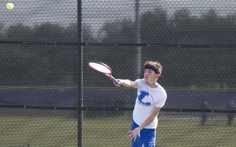 Clayton Shaw follows through on a serve during a previous match for the Badger tennis squad. HUNTER KING | DISPATCH RECORD