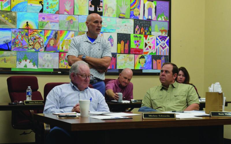 Assistant Superintendent Dana Holcomb, standing, provides highlights from the most recent Texas Academic Performance Report to Lampasas ISD trustees. Holcomb, who oversees curriculum matters for the school district, said that in 18 of 20 different STAAR tested areas, students here outperformed their counterparts across the state. ERICK MITCHELL | DISPATCH RECORD