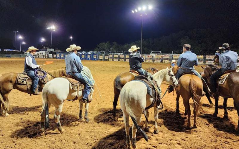 At far left is CPRA judge Bill Herbert, a former four-time CPRA saddle bronc champion. He awaits with entrants for the start of the team roping event at the 2023 Riata Roundup Rodeo held at the 580 West Sports Complex in Lampasas. file photo