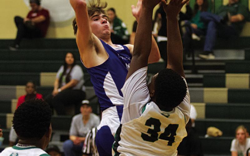 Jax Pratus shoots over an outstretched player. HUNTER KING | DISPATCH RECORD