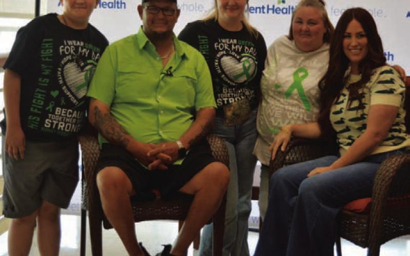 Michael Miller, seated, and his son Brycen, daughter Shaylee and wife Amy meet with Brandy Watkins, at right, during a news conference Monday. Watkins has qualified to be a kidney donor for the Lometa man who has been on dialysis for several years. ERICK MITCHELL | DISPATCH RECORD