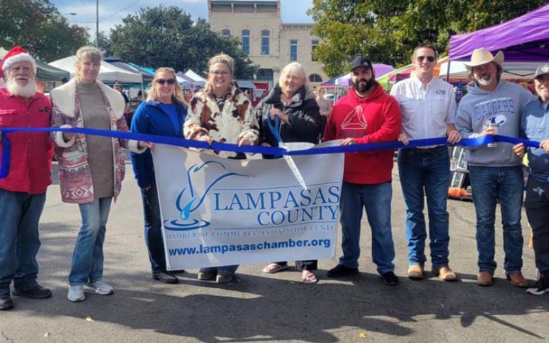 On hand for an official ribbon-cutting event last week were vendors, friends and Lampasas County Chamber of Commerce staff who welcomed Lampasas County Farmers Market &amp;amp; Crafts to the downtown courthouse square. Holding the ceremonial scissors is Arlene Banks, co-organizer of the market. courtesy photo