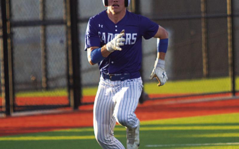 HUNTER KING | DISPATCH RECORD Jonathan Bowling races toward home plate against Jarrell.