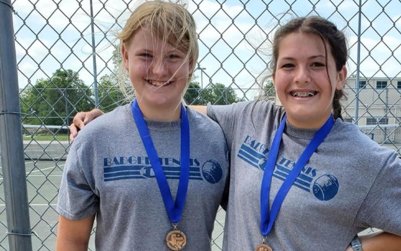 Seventh-graders Sydney Unger, left, and Tyler Wells took third in girls’ doubles at the district tournament. COURTESY PHOTO