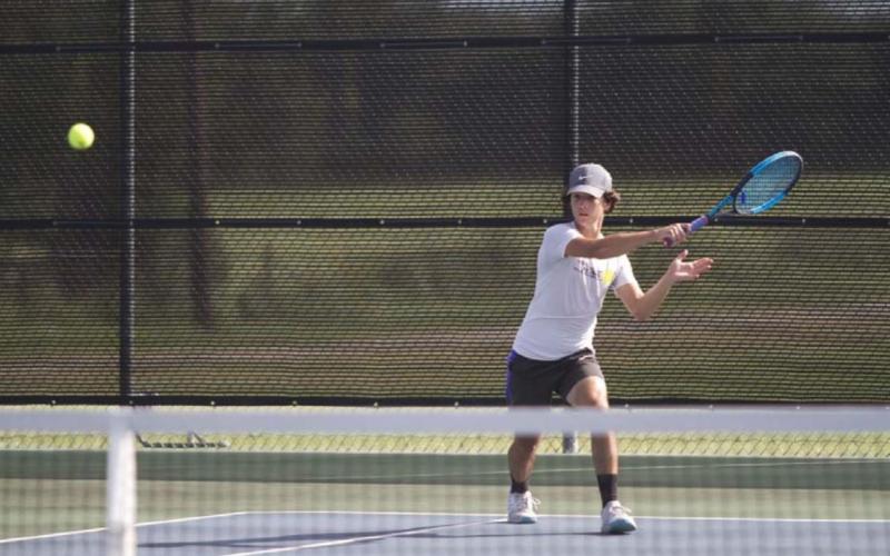HUNTER KING | DISPATCH RECORD Elias Arellano follows through on a forehand shot during a doubles match earlier this season.