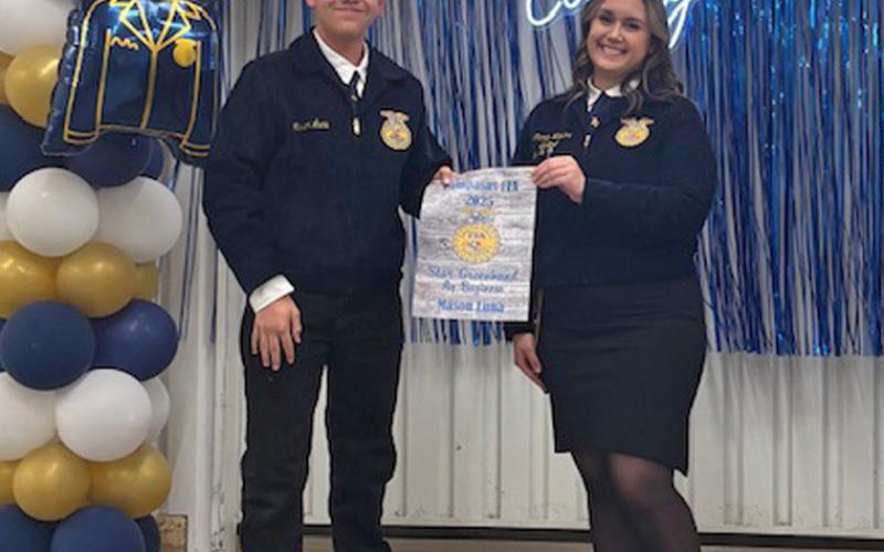 Mason Luna receives his Star Greenhand award from FFA officer Trinity Watkins. Luna garnered the award for his work in Agribusiness. COURTESY PHOTO