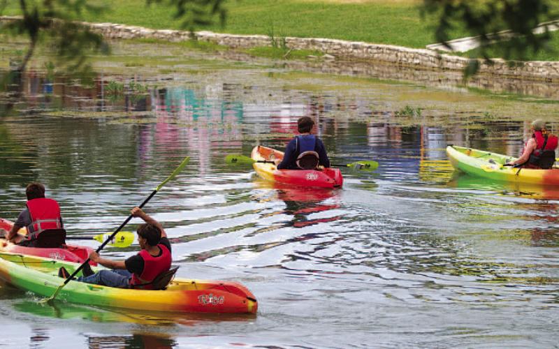 Kids and adults kayak through Sulphur Creek in W.M. Brook Park during the annual festival. HUNTER KING | DISPATCH RECORD
