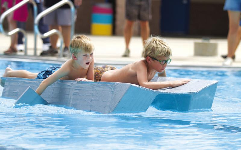 HUNTER KING | DISPATCH RECORD Tate Scott and Truman Scott work hard to paddle their boat to the finish line.