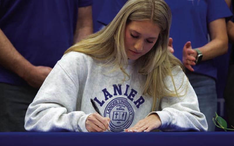 Breana Pelbath signs her letter of intent to Lander University. HUNTER KING | DISPATCH RECORD
