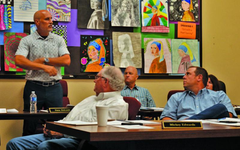 Lampasas ISD Assistant Superintendent Dana Holcomb, standing, gives school board members a presentation on 2024 STAAR test scores. ERICK MITCHELL | DISPATCH RECORD