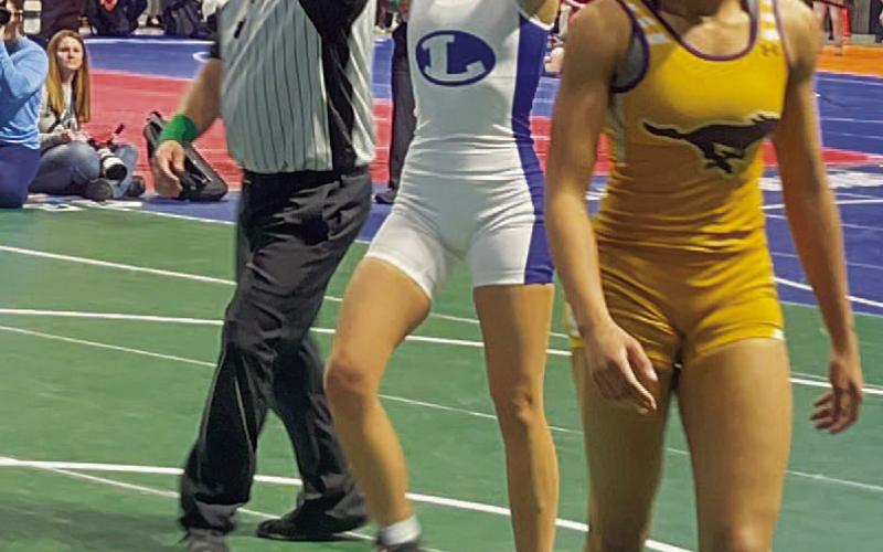 Freese throws her hands up after winning a match at state. COURTESY PHOTO | LHS WRESTLING TWITTER
