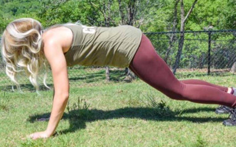 A woman pushes herself up out of the bottom of a burpee movement. COURTESY PHOTO