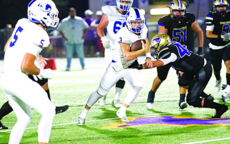 Reed Jerome runs through an attempted tackle against Marble Falls last Friday night. HUNTER KING | DISPATCH RECORD