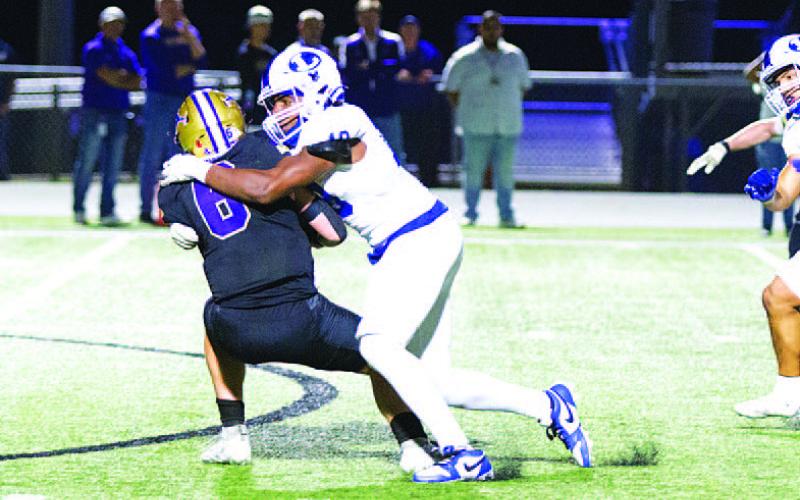 HUNTER KING | DISPATCH RECORD Trenton Hobbs brings down the quarterback for one of his three sacks in last week’s game.