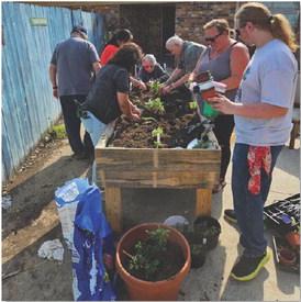 courtesy photo | Gail Eltgroth Browning Community Garden Club members are joined by Lily Springs Rehabilitation and Healthcare Center residents as they plant new items in the raised garden beds at the center.