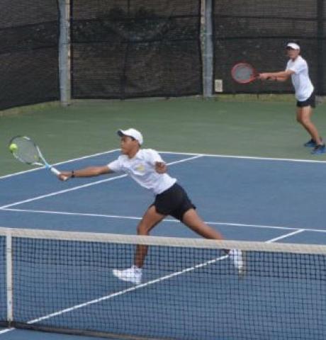 Mario Aguirre hits the ball near the net while Sam Zmolik plays the baseline in the boys’ doubles quarterfinals match at regionals. KENNETH PEISER | COURTESY PHOTO