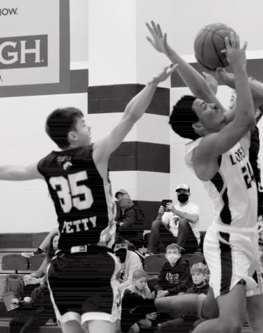 Dyllen Workmon, far right, shoots in close coverage in Tuesday’s non-district game. EMILY ANDRADE | LOMETA ISD YEARBOOK