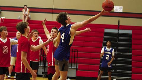 Calum Mitchell lays a ball off the glass during the Badgers’ summer league game against Salado on Wednesday. HUNTER KING | DISPATCH RECORD