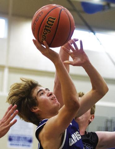 HUNTER KING | DISPATCH RECORD Jax Pratus finishes a layup through contact during Tuesday’s game against Richland Springs.