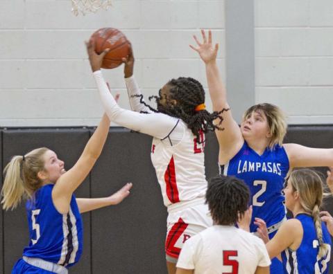 Laurcy Bender (5), Morgan Lovejoy (2) and Payton Tatum (far right) defend against Texas A&amp;M signee Eriny Kindred in a 64-32 win over Del Valle on Friday. JEFF LOWE | DISPATCH RECORD