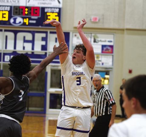 HUNTER KING | DISPATCH RECORD Aidan Nuckles shoots over an outstretched hand to knock down one of his three long-range shots during the season opener.