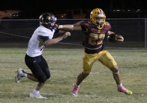 Lukas Smailus-Cruz stiff arms a defender during a run. MASON HINES | DISPATCH RECORD