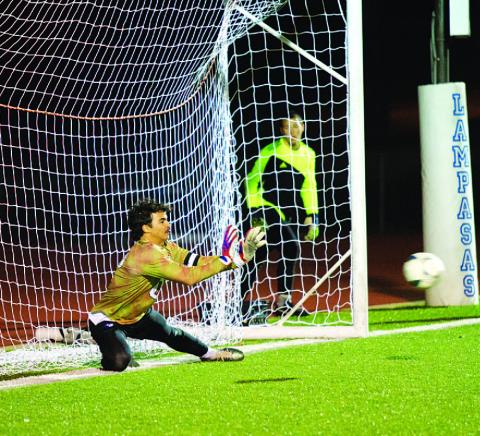 HUNTER KING | DISPATCH RECORD Michael Clayton dives to save a penalty kick against the Brownwood Lions last Friday night.