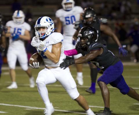 Ethan Moreno runs away from an LBJ defender during last Friday’s district game in Austin. HUNTER KING | DISPATCH RECORD