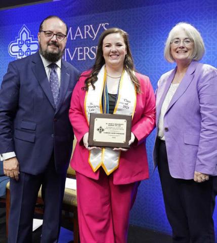 Recent St. Mary’s University School of Law graduate Carson Faith Wienecke of Lometa, center, was named a 2025 All-American Appellate Advocate by the National Association of Legal Advocacy, the first recipient in the law school’s history and one of only 20 awarded nationally. Pictured with her are A.J. Bellido de Luna, St. Mary’s University School of Law Assistant Dean for Advocacy and Conflict Resolution Programs, and St. Mary's School of Law Dean Patricia Roberts. COURTESY PHOTO