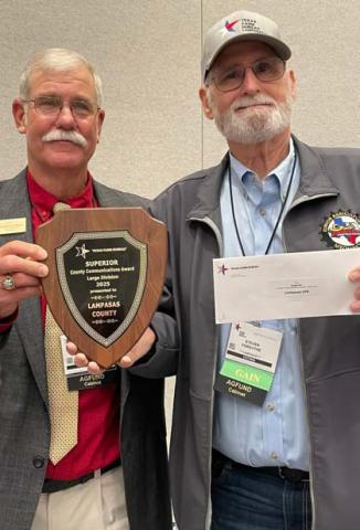 Texas Farm Bureau District 8 State Director Michael Moon of Bell County, at left, presents an award plaque and $250 check to Lampasas County Farm Bureau, represented here by director and publicity coordinator Dr. Steve Forsythe. Lampasas County was recognized as a superior Farm Bureau for its communications/ social media efforts in agricultural advocacy.