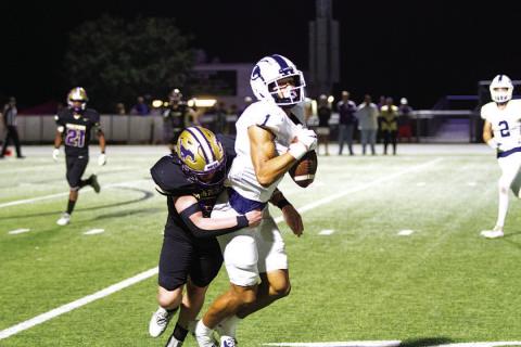 Ty Johnson makes a catch while getting hit against Marble Falls in the regular-season finale. HUNTER KING | DISPATCH RECORD