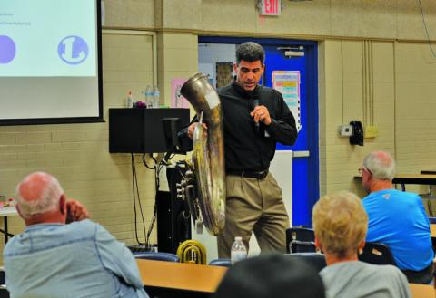 Superintendent Dr. Chane Rascoe holds up a worn-out tuba to illustrate the band’s need for new instruments. With an auditorium off the table, the school district hopes to include $1 million for fine arts upgrades in a 2026 bond. ERICK MITCHELL | DISPATCH RECORD