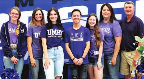 April Smith, left center, and Sam Zmolik, right center, pose with their families. CHRIS MILES | COURTESY PHOTO
