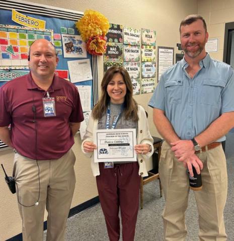 Spanish teacher Denisse Eddings has been selected as a Teacher of the Month at Lampasas High School. “She is a quick learner and demonstrates what a good teacher looks like with her calm demeanor and great relationships with her students,” said Assistant Principal Ryan Race. On hand to congratulate Eddings are Principal Paul Weinheimer, left, and Clay Phillips of Texas Farm Bureau Insurance. COURTESY PHOTO