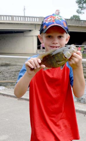 Bobby Chaney shows off his 8.5-inch catch. He tied at first place for longest catch in the 7- to 8-year-old division. MONIQUE BRAND | DISPATCH RECORD