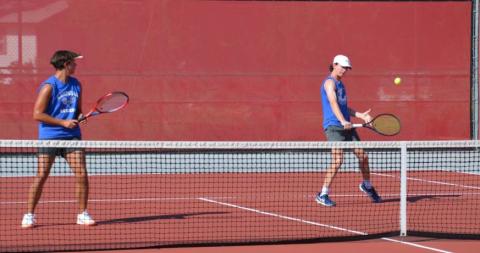 HUNTER KING | DISPATCH RECORD Elijah Copeland, right, plays a shot as Clyde Ashfield looks on during their doubles match against Glen Rose.