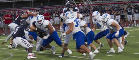 Sosa Sokimi breaks through the Wimberley offensive line to make a tackle during the game on Friday. HUNTER KING | DISPATCH RECORD