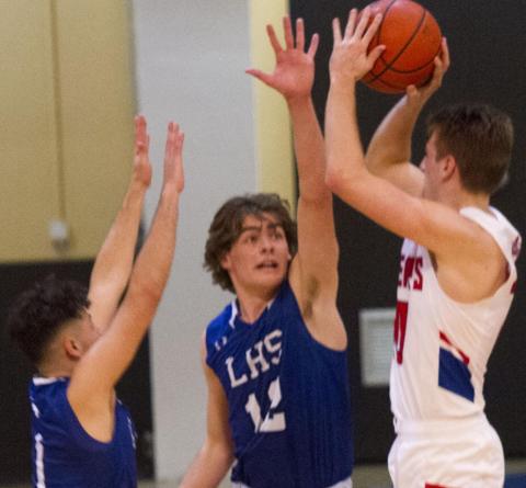 Landon Mulcahy (12) and Anthony Ortiz (1) defend the perimeter on Tuesday. The Badgers did not allow a single three-pointer by Graham in the 77-68 bi-district victory in Brownwood. JEFF LOWE | DISPATCH RECORD