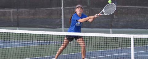 Allison Valdez reaches out on her backhand during a doubles match with her sister, Abby, on Friday. HUNTER KING | DISPATCH RECORD