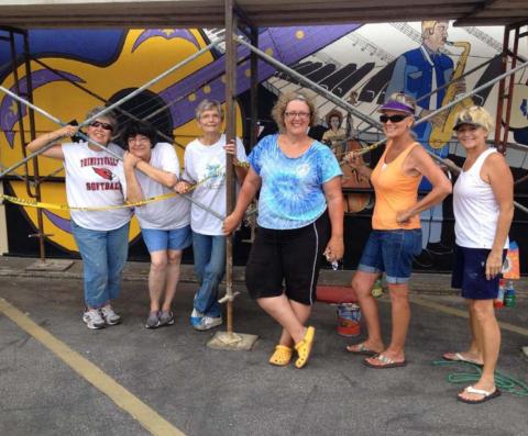 Vision Lampasas members pose for a picture as they paint “Small Town . . . Big Sound.” COURTESY PHOTO