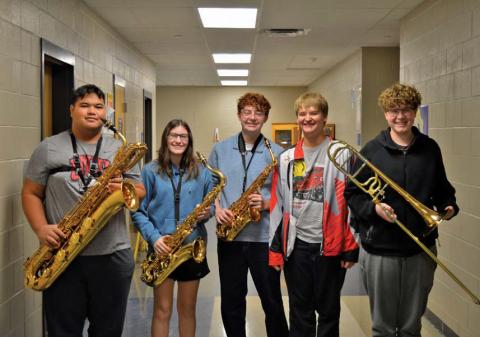erick mitchell | dispatch record Band members, from left, Sasa Soki, Maddi Griffin, Jacob Whaley, Alexander Thorne and Charlie Pekins pose with their instruments. All five placed in the top 12 for the state jazz band competition with their respective instruments.