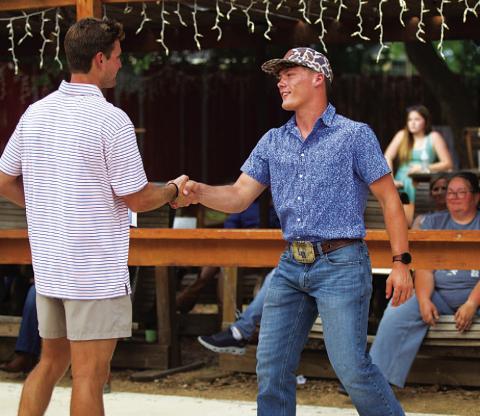 Corbin Kepler shakes the hand of coach Hadley Berry after receiving the Battlin’ Badger award. HUNTER KING | DISPATCH RECORD