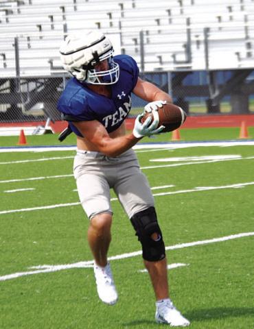 HUNTER KING | DISPATCH RECORD Carter Johnson hauls in a pass during practice on Tuesday as the Badgers prepare for the season opener.